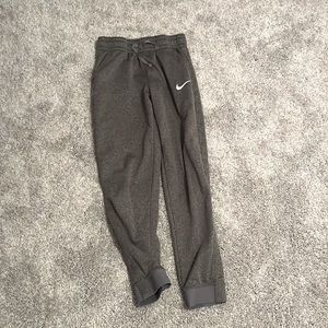 dark grey nike sweatpants.